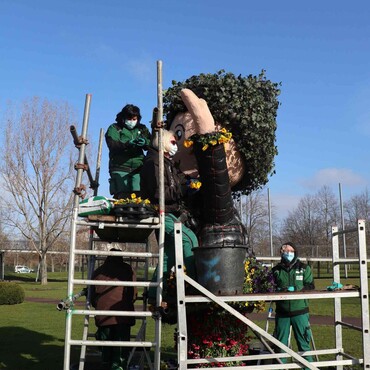 Die Sandmannfigur im Elbauenpark wird von Gärtnern mit Blumen bepflanzt